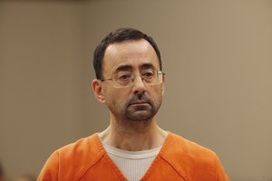 Dr. Larry Nassar, 54, appears in court for a plea hearing in Lansing, Mich., Wednesday, Nov. 22, 2017. Nasser, a sports doctor accused of molesting girls while working for USA Gymnastics and Michigan State University pleaded, guilty to multiple charges of sexual assault and will face at least 25 years in prison.(AP Photo/Paul Sancya)