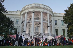 President Donald Trump and first lady Melania Trump hand out treats as they welcome children from the Washington area and children of military families to trick-or-treat celebrating Halloween at the South Lawn of the White House in Washington, Monday, Oct. 30, 2017.