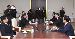 In this photo released by the South Korean Unification Ministry, South Korea's Unification Policy Officer Chun Hae-sung, left, and the head of North Korea's delegation Kim Song Hye read statements during their meeting at the southern side of Panmunjom