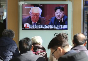 People watch a TV screen showing images of U.S. President Donald Trump, left, and North Korean leader Kim Jong Un at the Seoul Railway Station in Seoul, South Korea, Tuesday, Nov. 21, 2017.