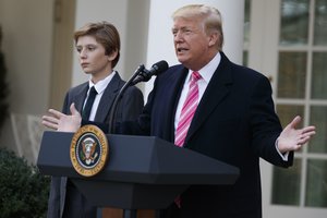 Barron Trump listens as President Donald Trump speaks during the National Thanksgiving Turkey Pardoning Ceremony in the Rose Garden of the White House, Tuesday, Nov. 21, 2017, in Washington.