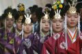 Female students of the Kokugakuin University who'll be turning 20 years old in 2018, wear kimonos dress as they ...