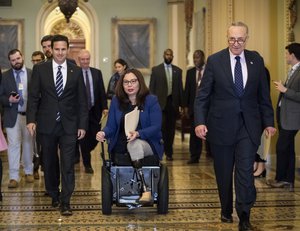 From left, Sen. Brian Schatz, D-Hawaii, Sen. Tammy Duckworth, D-Ill., and Senate Minority Leader Chuck Schumer, D-N.Y., arrive for a news conference following a weekly strategy session, on Capitol Hill in Washington, Tuesday, Nov. 7, 2017.