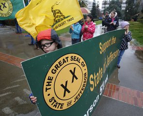 Stephen Wontorek, 12, of Fiddletown, Calif., holds a a sign calling for the creation of the state of Jefferson, during a rally at the Capitol on Wednesday, Jan. 6, 2016, in Sacramento, Calif.