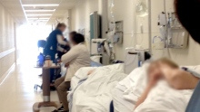 Blurred patients being treated in Surrey Memorial Hospital ER corridor