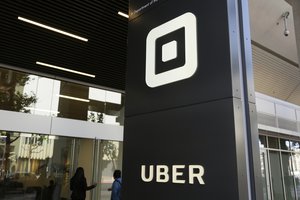 People make their way into the building that houses the headquarters of Uber, Wednesday, June 21, 2017, in San Francisco.