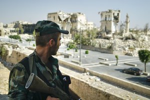 A Syrian soldier guards streets in Aleppo, Syria, on Tuesday, Sept. 12, 2017.