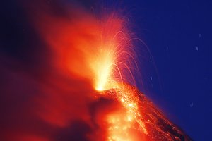 A "fountaining" of Mayon volcano is seen during its eruption for the second straight day Tuesday, Jan. 23, 2018 as seen from Legazpi city, Albay province around 200 miles (340 kilometers) southeast of Manila, Philippines.