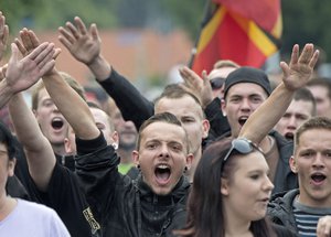 In this Friday, June 26, 2015 file photo protestors demonstrate against the accommodation for immigrants in Freital, Germany, near Dresden.