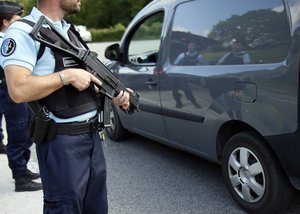 French police officers check vehicles at the border crossing between Spain and France in Dantcharia, southwestern France, Saturday, Aug.19, 2017.