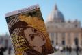 Pope Francis book on "Fake News", is pictured in front of St. Peter's Basilica, in Rome.