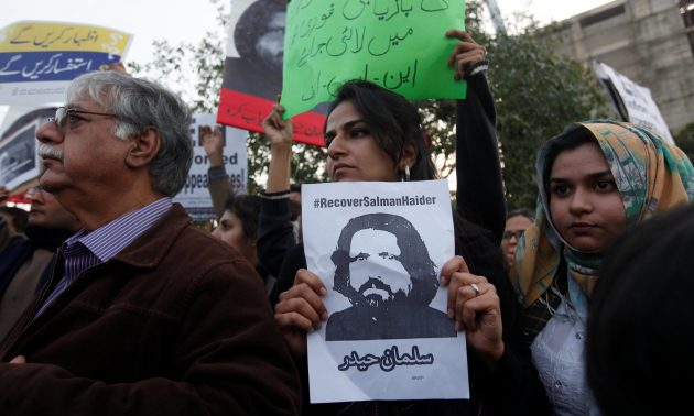 Human rights activists hold up a picture of Salman Haider, who went missing during a protest to condemn the disappearances of social activists in Karachi. Photo: Reuters