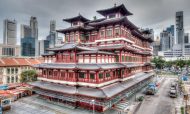 A rendering of the Buddha Tooth Relic Temple in Singapore's Chinatown, with the city's skyscraper business district in the background. Image: iStock/Getty Images