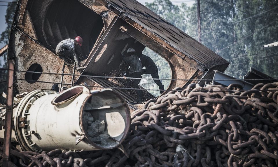 Workers in a shipbreaking yard in Chittagong, Bangladesh, with flame cutters breaking parts of a shipwreck. Photo: AFP