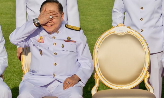 Thailand's junta number two Prawit Wongsuwan covers his eyes, displaying a watch he is wearing, during a photo call with other members of a new cabinet in Bangkok.
Photo: AFP/ Krit Phromsakla Na Sakolnakorn