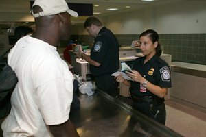 File - Border control at a US Airport, measures used to monitor or regulate its borders.