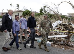 President Donald Trump takes a walking tour to survey hurricane damage and recovery efforts in a neighborhood in Guaynabo, Puerto Rico, Tuesday, Oct. 3, 2017.