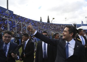 Honduran President Juan Orlando Hernandez gives a thumbs up to supporters as he arrives to be sworn in for a second term, at the National Stadium in Tegucigalpa, Honduras, Saturday, Jan. 27, 2018.