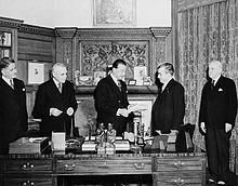 Harold Alexander at desk receiving legislation