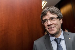 Ousted Catalan leader Carles Puigdemont arrives to address the media after a meeting with the President of the Parliament of Catalonia Roger Torrent in Brussels on Wednesday, Jan. 24, 2018.