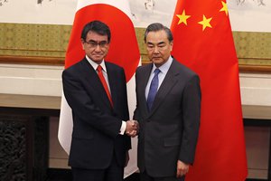 Japanese Foreign Minister Taro Kono, left, and Chinese counterpart Wang Yi pose for photographs