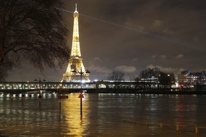 A flooded street lamp and signboards are pictured next to the river Seine in Parison the river Seine in Paris, Saturday, Jan. 27, 2018.