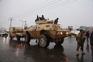 Afghan security personnel arrive at the site of attack at military academy in Kabul, Afghanistan. Monday, Jan. 29, 2018.