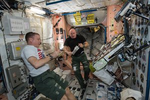 File -  It's mealtime on the International Space Station. NASA astronauts Terry Virts (left) and Scott Kelly (right) take a rest from their duties and enjoy some of the special foods prepared for them to eat while in microgravity, 4 April, 2015.