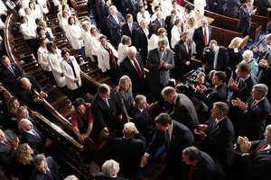 Women Democratic member of Congress, wearing white inn honor of women's suffrage, watch as President Donald Trump arrives on Capitol Hill in Washington, Tuesday, Feb. 28, 2017, to address a joint session of Congress.