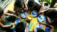 Orphans at the Wat Norea home eat dinner