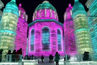 Visitors walk among the attractions at the Harbin International Ice and Snow Festival in Harbin in northeastern China's ...