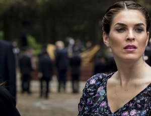 President Donald Trump's White House Communications Director Hope Hicks stands near President Donald Trump, background, following a news conference between President Donald Trump and Vietnamese President Tran Dai Quang at the Presidential Palace, Sunday, Nov. 12, 2017, in Hanoi, Vietnam.