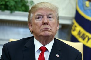 President Donald Trump listens during a meeting with North Korean defectors where he talked with reporters about allowing the release of a secret memo on the F.B.I.’s role in the Russia inquiry, in the Oval Office of the White House, Friday, Feb. 2, 2018, in Washington.