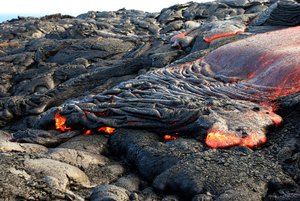 In this Monday, Aug. 8, 2016 photo, lava from Kilauea, an active volcano on Hawaii's Big Island, flows toward the ocean in Volcanoes National Park near Kalapana, Hawaii.