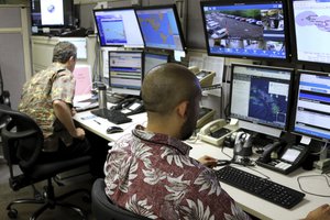 In this Dec. 1, 2017 file photo, Hawaii Emergency Management Agency officials work at the department's command center in Honolulu.