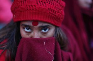 A Nepalese Hindu woman waits to start rituals during Madhav Narayan festival.