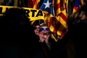 People gather outside the Catalonia parliament during a parliamentary session in Barcelona, Spain. A new Catalan ...