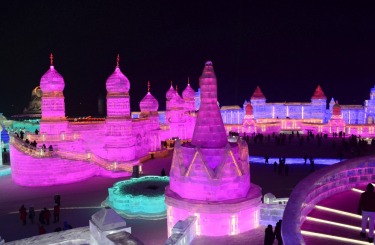 Visitors walk among the attractions at the Harbin International Ice and Snow Festival in Harbin in northeastern China's ...