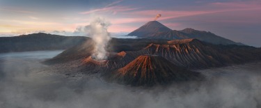 A view of Mount Bromo and Mount Semeru spewing ashes while Mount Batok remains inactive in the island of Jawa, Indonesia.