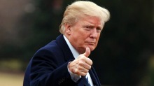 President Donald Trump gives a thumbs up as he walks on the South Lawn of the White House after arriving aboard Marine ...