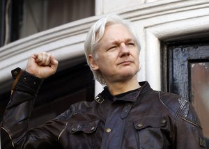 Julian Assange greets supporters outside the Ecuadorian embassy in London, Friday May 19, 2017.