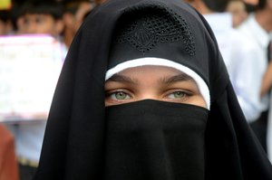 A girl wearing burqa takes out a rally titled “Heritage Walk” in the old city of Srinagar,India, Wednesday 22, July 2015. To highlight the rich heritage of the Jammu and Kashmir and to call for its preservation.