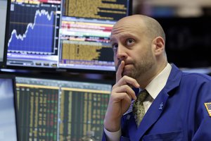 Specialist Meric Greenbaum works on the floor of the New York Stock Exchange. The Dow index, a symbol of investor euphoria and despair for decades