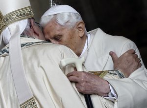 In this Tuesday, Dec. 8, 2015 file photo, Pope Emeritus Benedict XVI, right, hugs Pope Francis in St. Peter's Basilica during the ceremony marking the start of the Holy Year, at the Vatican.