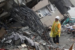 An official inspects the failed rebar foundation pillars during a continued search operation at an apartment building collapsed after a strong earthquake in Hualien County, eastern Taiwan, Thursday, Feb. 8, 2018.