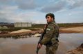 A Turkey-backed opposition fighter of the Free Syrian Army secures a checkpoint at the village of Maarin, in the ...