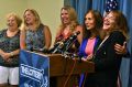 A winner exposed: Mavis Wanczyk, right, of Chicopee, Massachusetts., laughs beside state treasurer Deb Goldberg during a ...