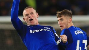 Everton's Wayne Rooney, left. celebrates scoring his side's third goal of the game during the English Premier League ...