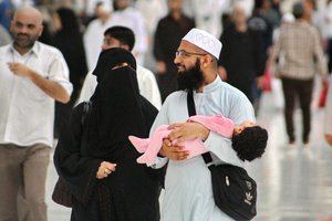 File - A young Muslim couple and their toddler at Masjid al-Haram, also called the Great Mosque of Mecca, Saudi Arabia.