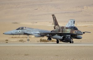 File - An Israeli F-16 air force plane, front, and an Israeli F-15, rear, drive to take off from Ovda airbase near Eilat, southern Israel, Monday, Nov. 25, 2013 during the Blue Flag exercise.